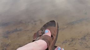 Birkenstock dangles by the sea
