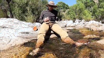 Horny dude goes to a creek in nature to jerk off