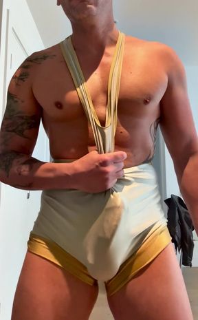 Muscle gym bro plays with his big cock in wrestling singlet