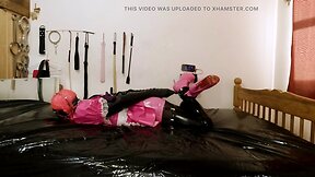 Maid hogtied and gagged in armbinder and steel chastity belt