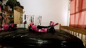 Maid hogtied and gagged in armbinder and steel chastity belt