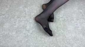 Mistress Caresses Her Feet in Black Nylon Pantyhose