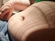 Chubby enby plays with big belly in the sunshine
