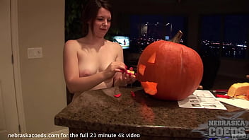 hot teen babe carving a pumpkin jack-o-lantern for halloween then fucking it