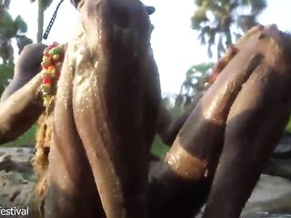Sexy slim Afro village woman bathing and teasing in a river