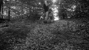 Naked submissive walking on a leash through the woods