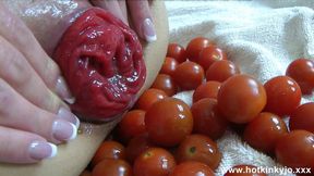 Kinky girl with huge tits plays with small tomatoes in her ass