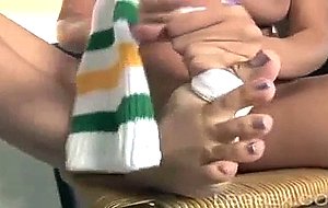 Hottie rubs her socks between her toes