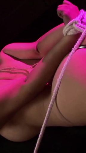 Vibrating her bound pussy to orgasm