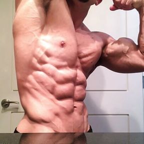 Jacked bodybuilder Benji Bastian flexing his huge, shredded, muscles