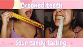Crooked teeth chewing sour candy