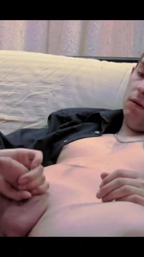A Dude in a Baseball Cap Undresses and Jerks off on the Couch