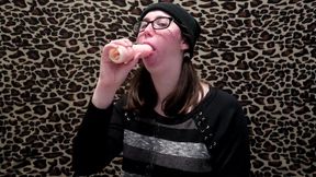 Nerdy girl practices her sloppy blowjob technique using a dildo while