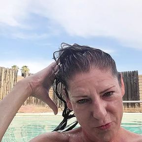 Naked swimming and smoking mature woman