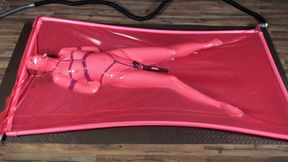 Rope bondage with vibro in a pink latex bed