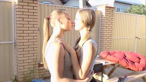 Blonde teens lick and tease each other's big tits after a walk