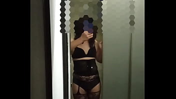 A transgender whore, embodying characteristics associated with labels such as shemale, tranny, crossdresser, tgirl, sissy, femboy, or ladyboy, she opens the restroom door, revealing her sensual figure.