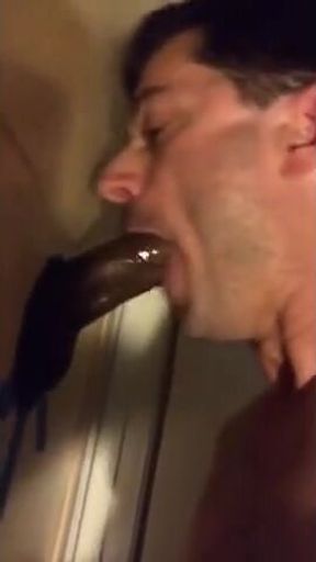 Amateur sucks big black cock at glory hole