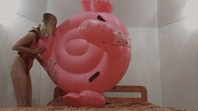 Alla is blowing up a big inflatable flamingo with her mouth!!!
