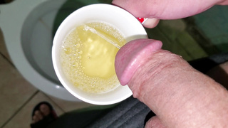 Guy Urinating in a Mug (close-up)