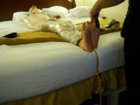 Tickled wrapped tied on bed