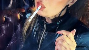 Filling her lungs, wearing a catsuit, ponytail, eyes lined in black, and Lipgloss - Dunhill Menthol 100