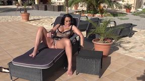 All alone by the pool in Mallorca, she gets really horny and rubs lube into her wet pussy before shoving the dildo into her big, wet hole.