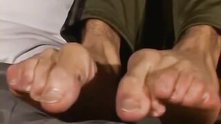 Brandon enjoys flashing his soles while milking his good-sized man meat