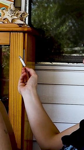 Shaved Head Goth Smokes Outside