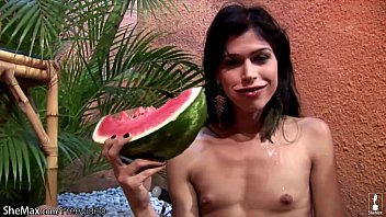 Chick with dick plays with her small titties and watermelon