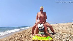 Busty mature blomde strap-on fucks her stepson on the beach