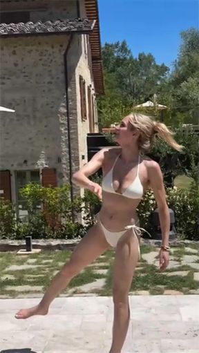 Woman in bikini playing frisbee