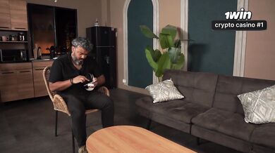 Busty stepmother plays with her stepson's cock while her husband plays on his console