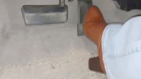 Evalynn driving in brown heeled boots 2