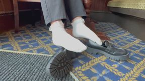 Close up public Shoeplay in loafers and white frilly socks