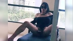 tranny stroking her big cock in her hotel balcony