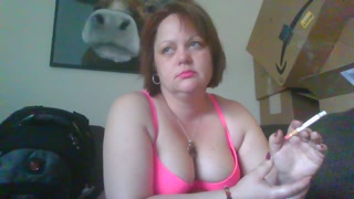 Just a sexy brunette smoking a cig.