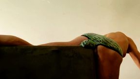 stretching groin and back in digitial camo briefs with bulge on couch