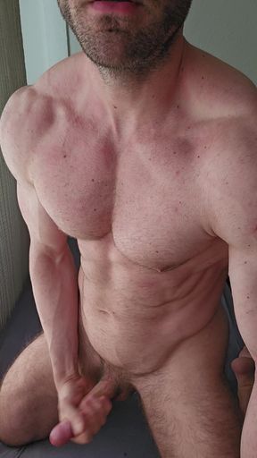 Big muscular stud jerking off big white cock