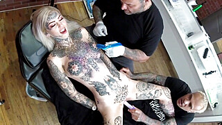 Sascha plays with Amber Luke while she gets tattooed