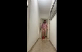 Hot Spanish trans girl walks down the hallway showing her ass in high red heels with a pretty dress