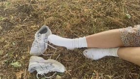 Shoeplay outdoors in sneakers and white socks