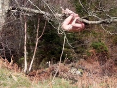 Naked self-bondage in the woods gone wrong.