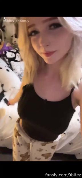 Blonde woman in black tank top and camo pants