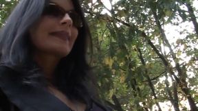 Hot and sexy milf fingers her pussy on the bench of a park