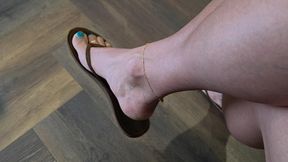 Feet dangle in flipflops