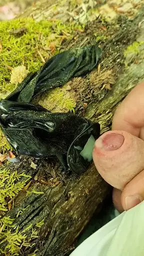 Outdoor cumshot in a used condom in the forest