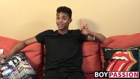 Black young man gives an interview and stimulates himself