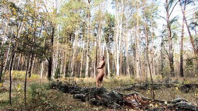 Naked Girl Walking in the autumn forest