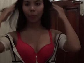 Sexy brunette Asian babe fools around with the camera